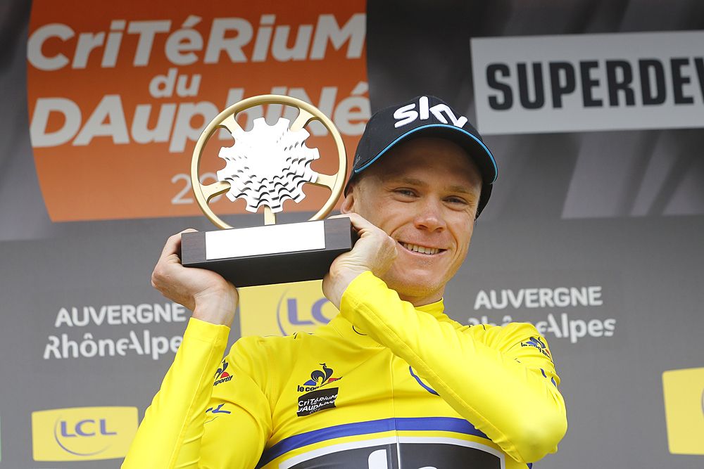 Chris Froome (Team Sky) raises the trophy after winning Criterium du Dauphine
