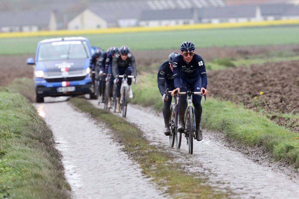 Team Groupama-FDJ riders cycle on the paved sector during a reconnaissance ride for the 121st edition of the Paris-Roubaix upcoming cycling event in Haveluy on April 5, 2024. (Photo by FRANCOIS LO PRESTI / AFP)
