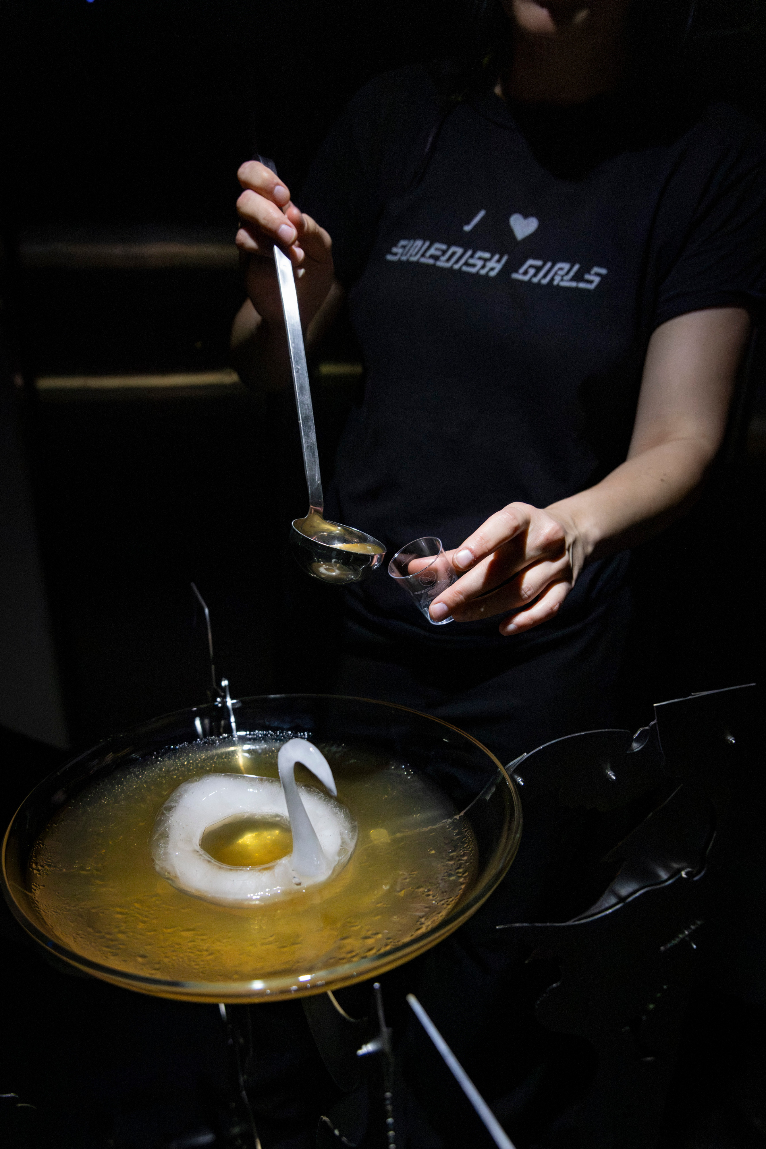 Dark room with person cooking with tools