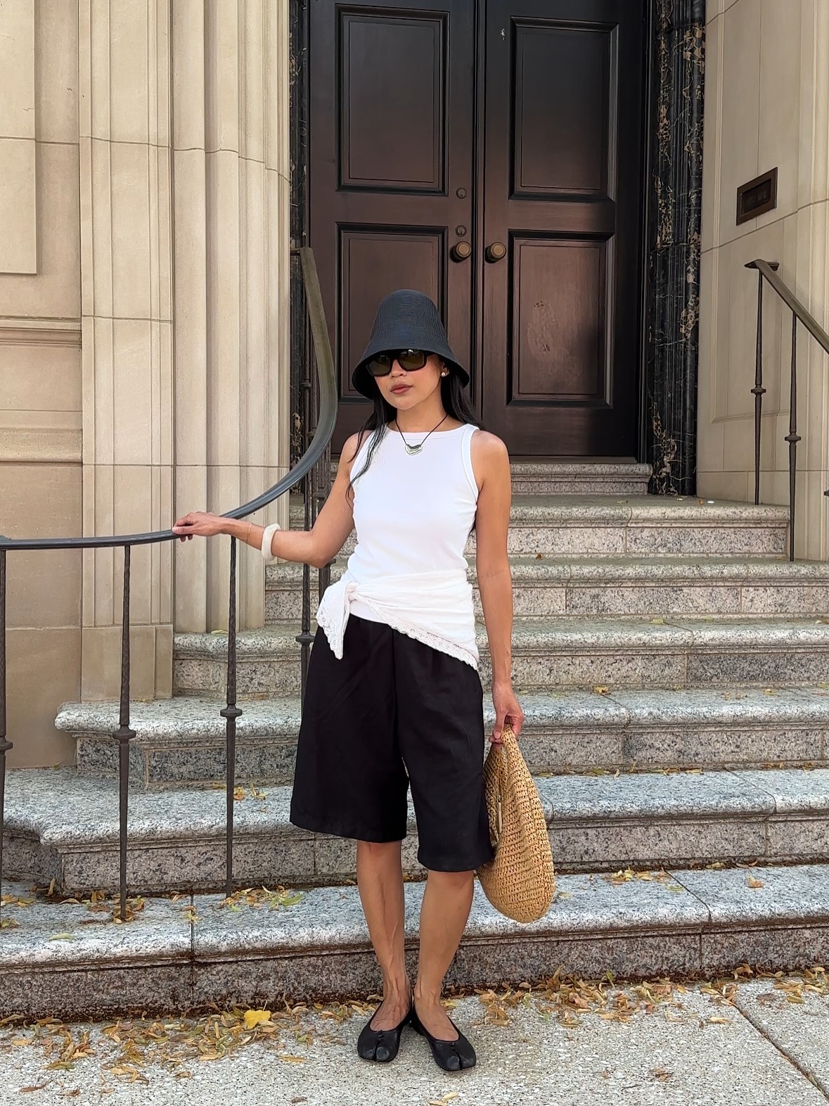 Woman wearing summer bucket hat outfit.