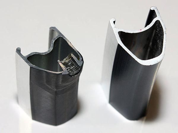The Dura-Ace carbon-and-aluminum clincher rims (left) use a thin-walled aluminum extrusion plus layers of reinforcing carbon fibre.