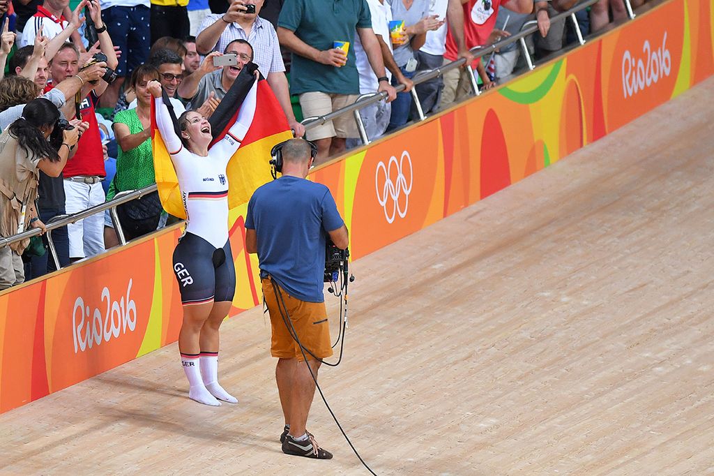 Kristina Vogel (Germany) celebrates with her spring gold with the German flag