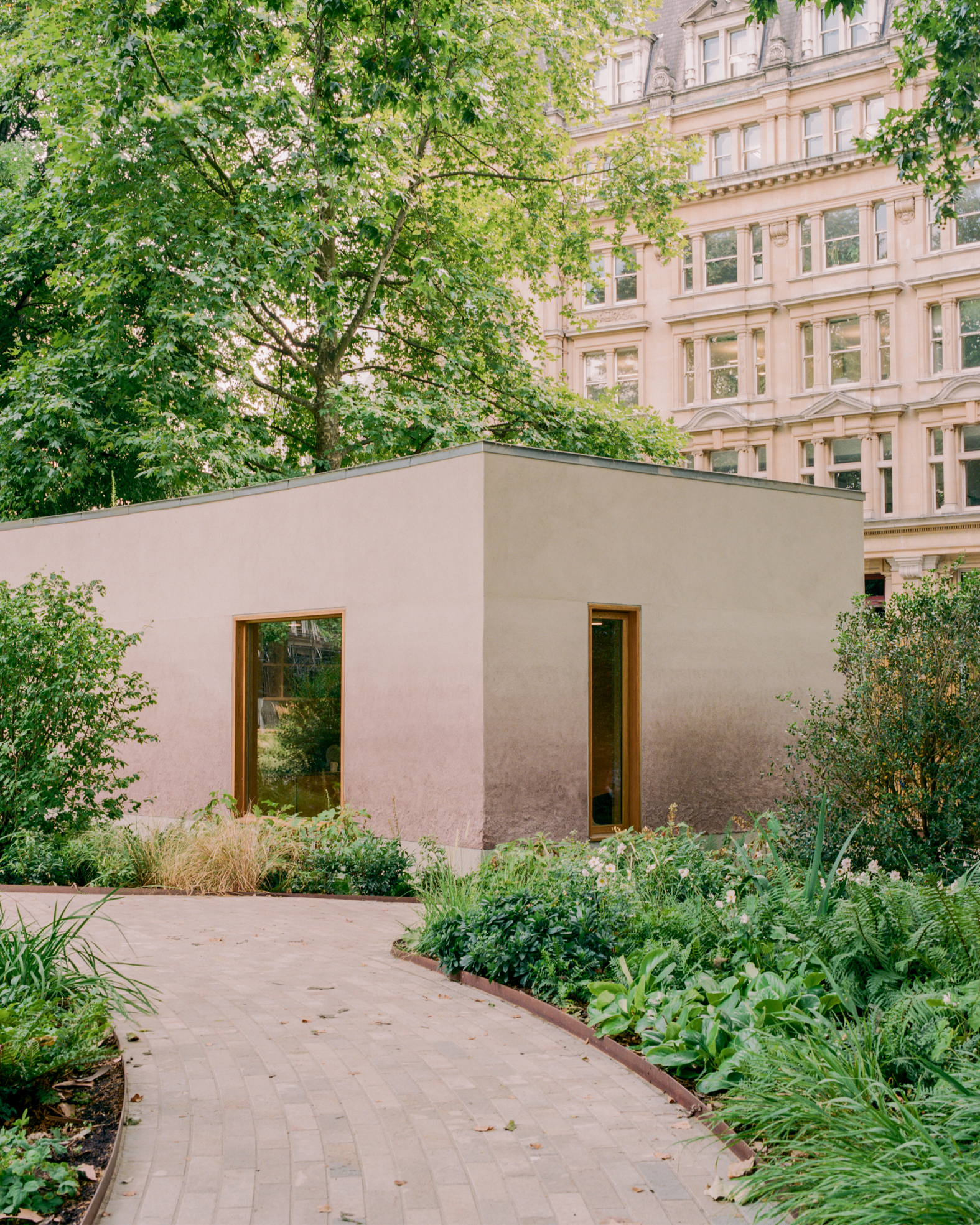 view of Finsbury Circus Parks Office, a minimalist, earthy building set among leafy garden