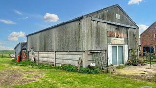 A barn with concrete frame and steel sheeting