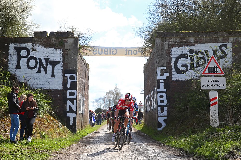 Riders make their way past Pont Gibus during the 2016 Paris - Roubaix