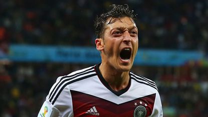 Mesut Ozil celebrates scoring the winner for Germany