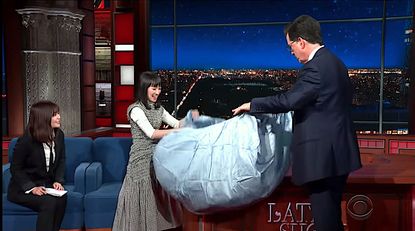 Marie Kondo shows Stephen Colbert how to fold a fitted sheet