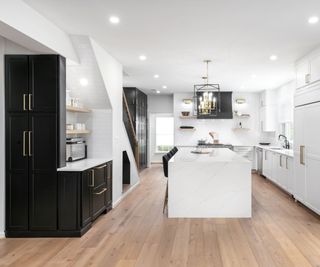 Kitchen with a mix of white cabinets and black cabinets