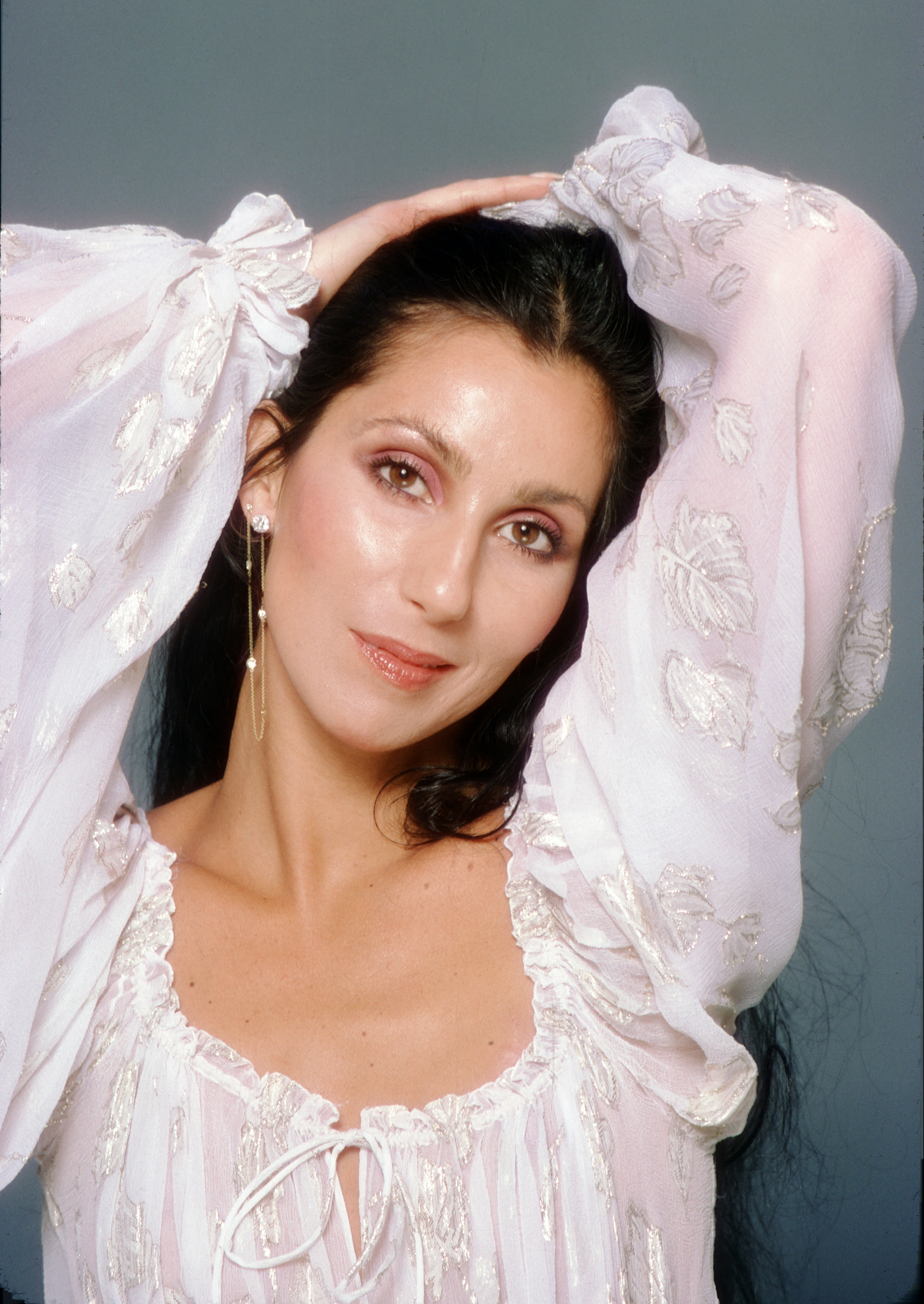 Cher with pink eyeshadow and glossy mauve lips in 1978