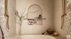 A walk-in shower with a bench that curves around the space, a waterfall showerhead, and two shower heads on opposing walls