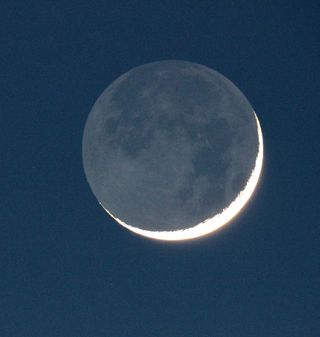 Skywatcher Scott Tully snapped this amazing view of the crescent moon on Dec. 28, 2011 while the moon appeared close to the planet Venus at sunset. The moon's dark section is illuminated by light reflected from Earth, called Earthshine.