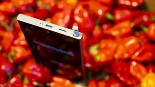 A Samsung Galaxy S24 Ultra sitting on top of a pile of red chillies