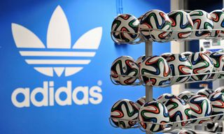 Brazuca match balls for the FIFA World Cup 2014 lie in a rack in front of the adidas logo on December 6, 2013 in Scheinfeld near Herzogenaurach, Germany. Brazuca is the Official Match Ball for the FIFA World Cup 2014 Brazil.