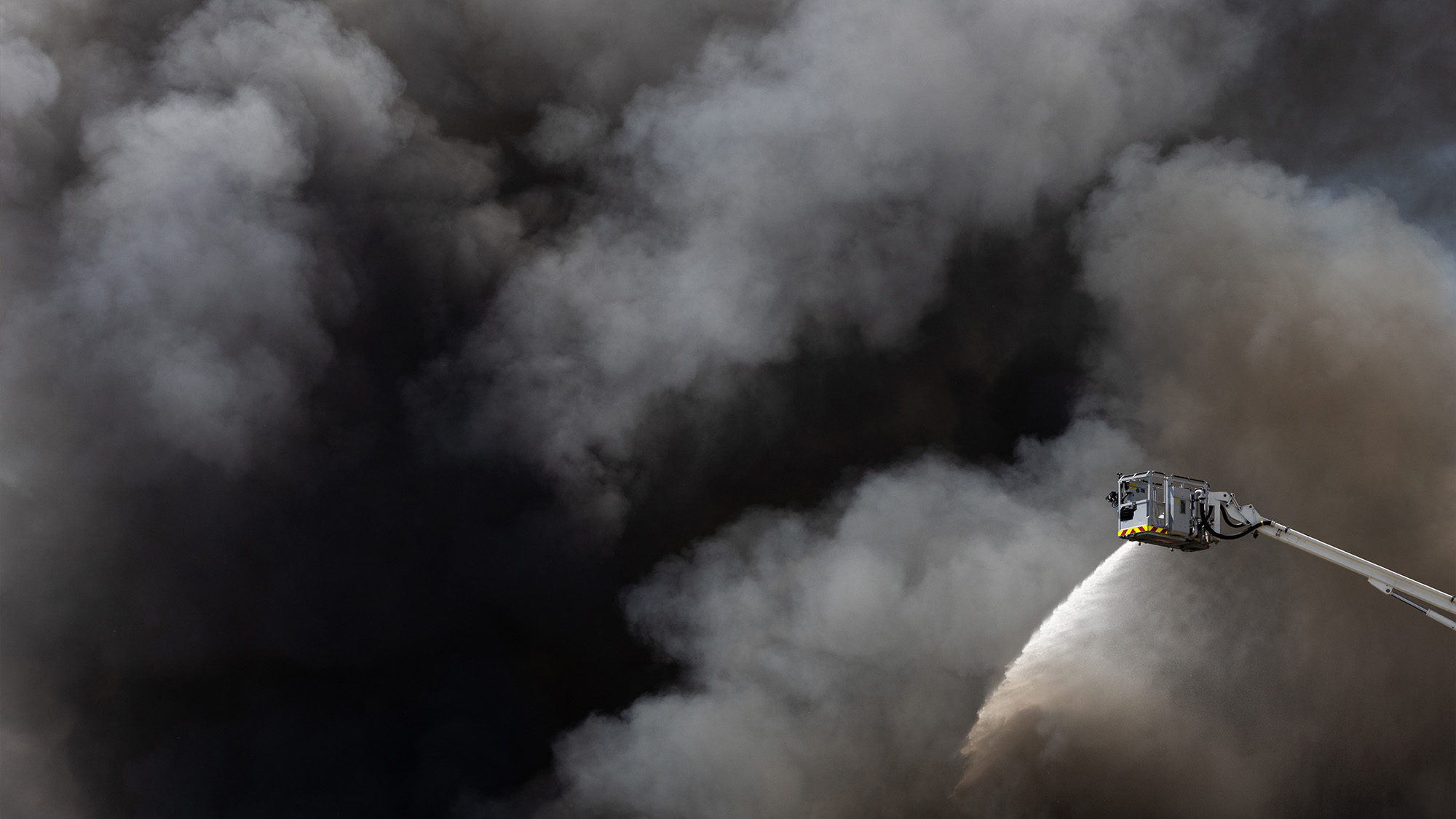 Parisian firefighters work to extinguish a fire at an industrial facility in Bobigny, France