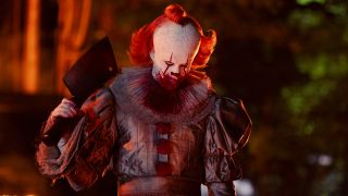 Bill Skarsgard as Pennywise holding a cleaver in IT: Welcome To Derry
