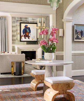 Entryway with marble table and wooden stools