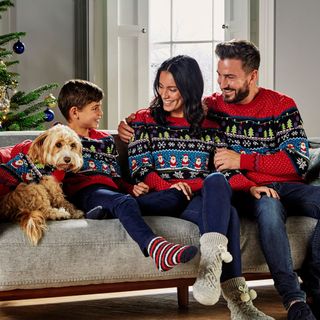 man women boy and dog wearing red jumpers