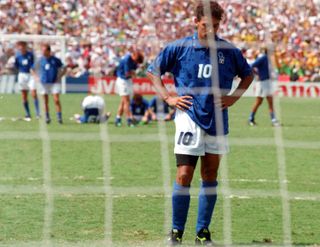 Roberto Baggio of Italy looks dejected, standing with his hands on his hips, after missing the decisive penalty of the shootout in the 1994 World Cup final against Brazil at the Rose Bowl in Pasadena, California, USA