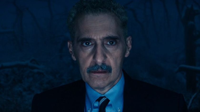 John Turturro as Irv looking concerned in Season 2 of Severance while standing in the dark.