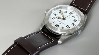 The Hamilton Khaki Field Expedition with a white dial on a grey background