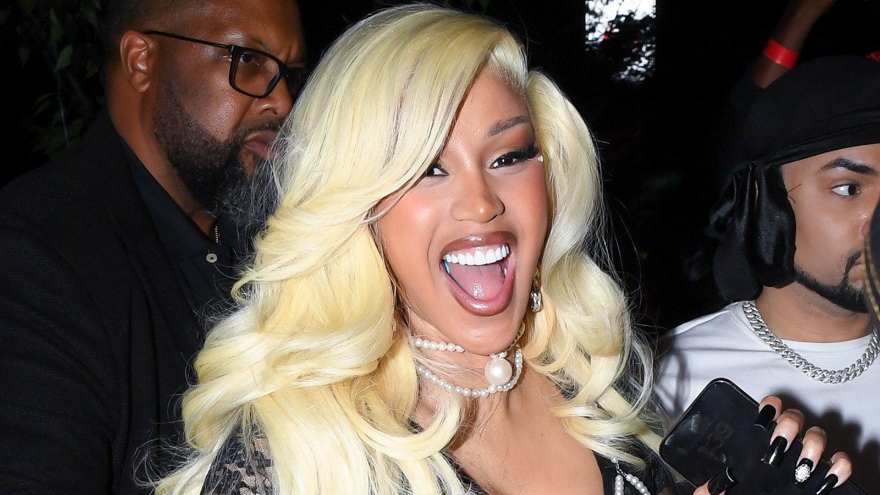 a latina woman with long, platinum blonde hair laughing mid photo