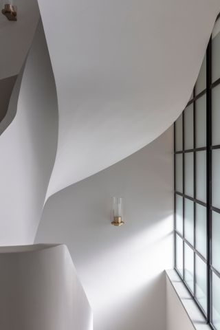 Curved white walls around spiral staircase
