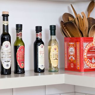 vinegar with wooden essentials and white shelves