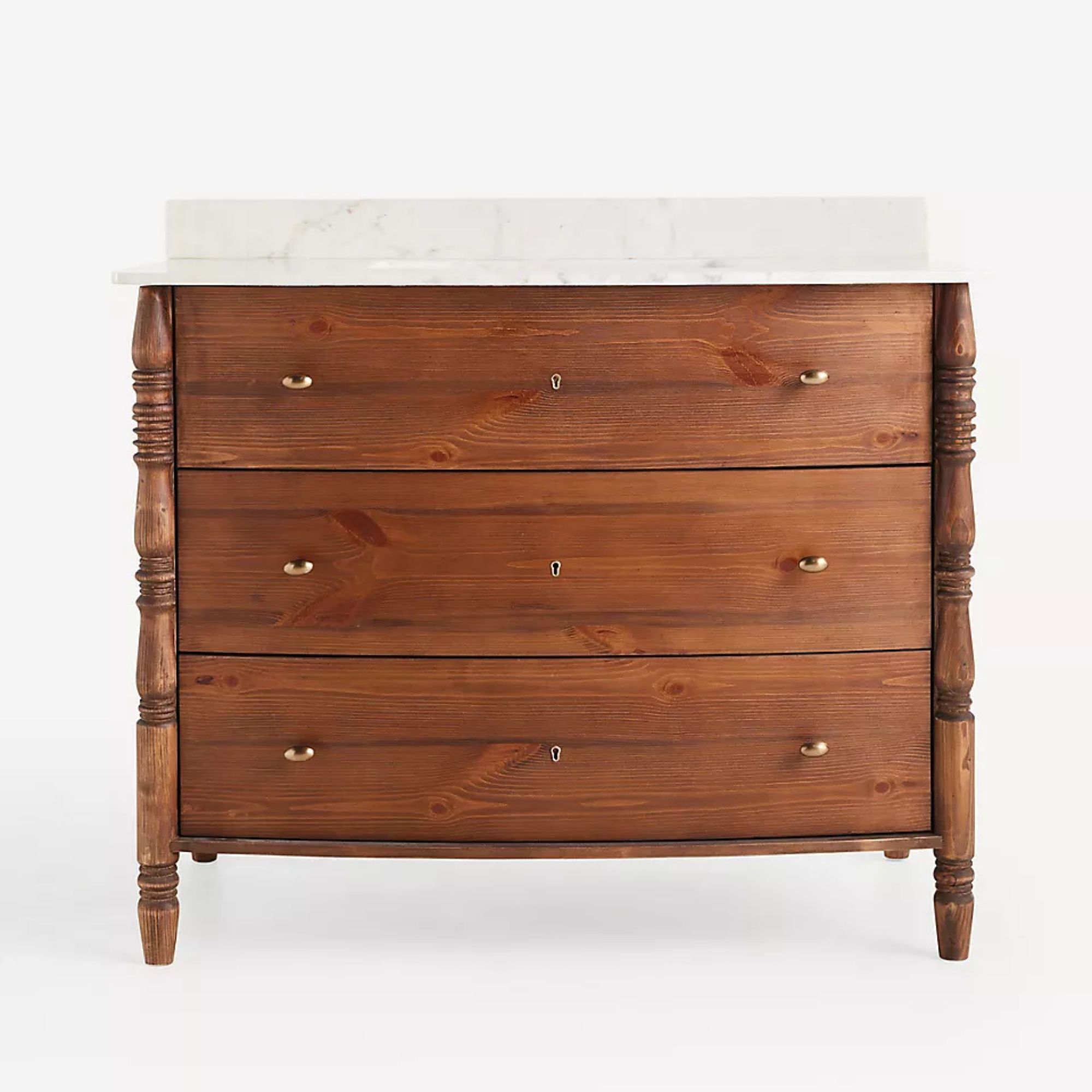 A wooden bathroom vanity with single legs and a marble top