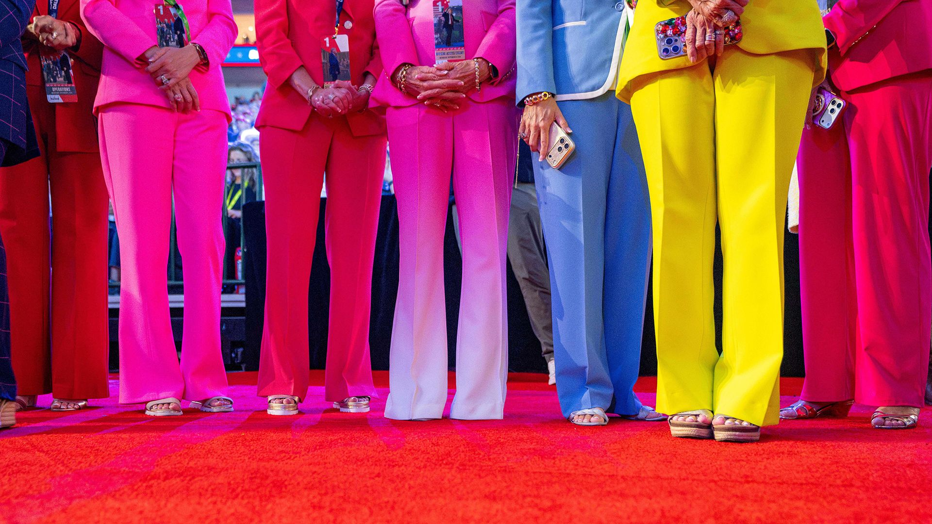 
                                A group of women in colourful suits stand and watch US President Donald Trump speak during the Midterm Republican National Convention at the American Airlines Center in Dallas, Texas
                            