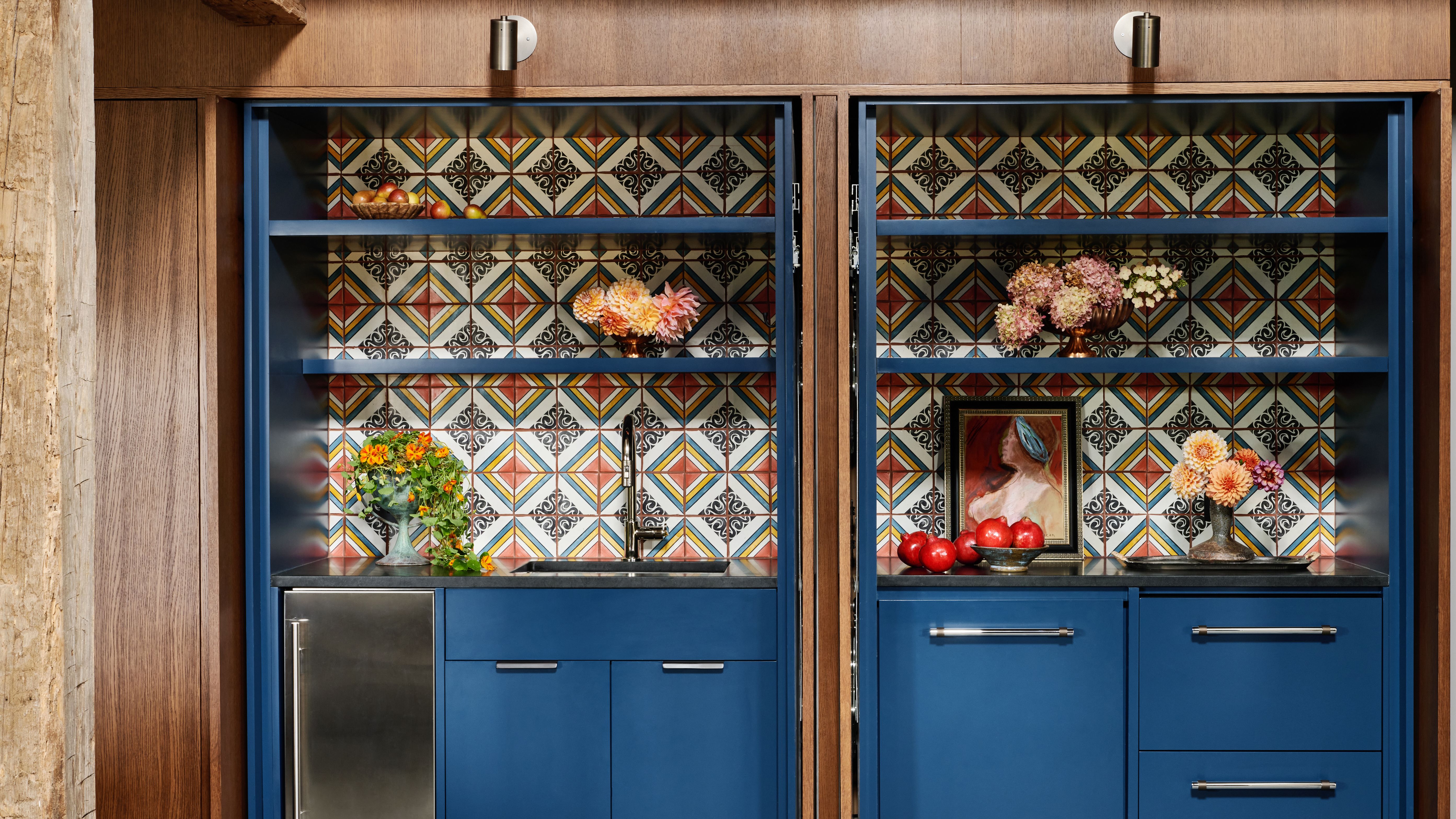 kitchen with blue cabinets and patterned tiles on the backsplash