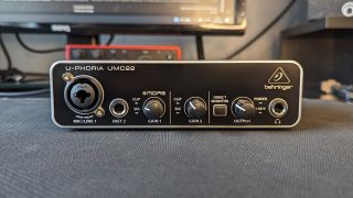 A Behringer UMC22 audio interface on a desktop