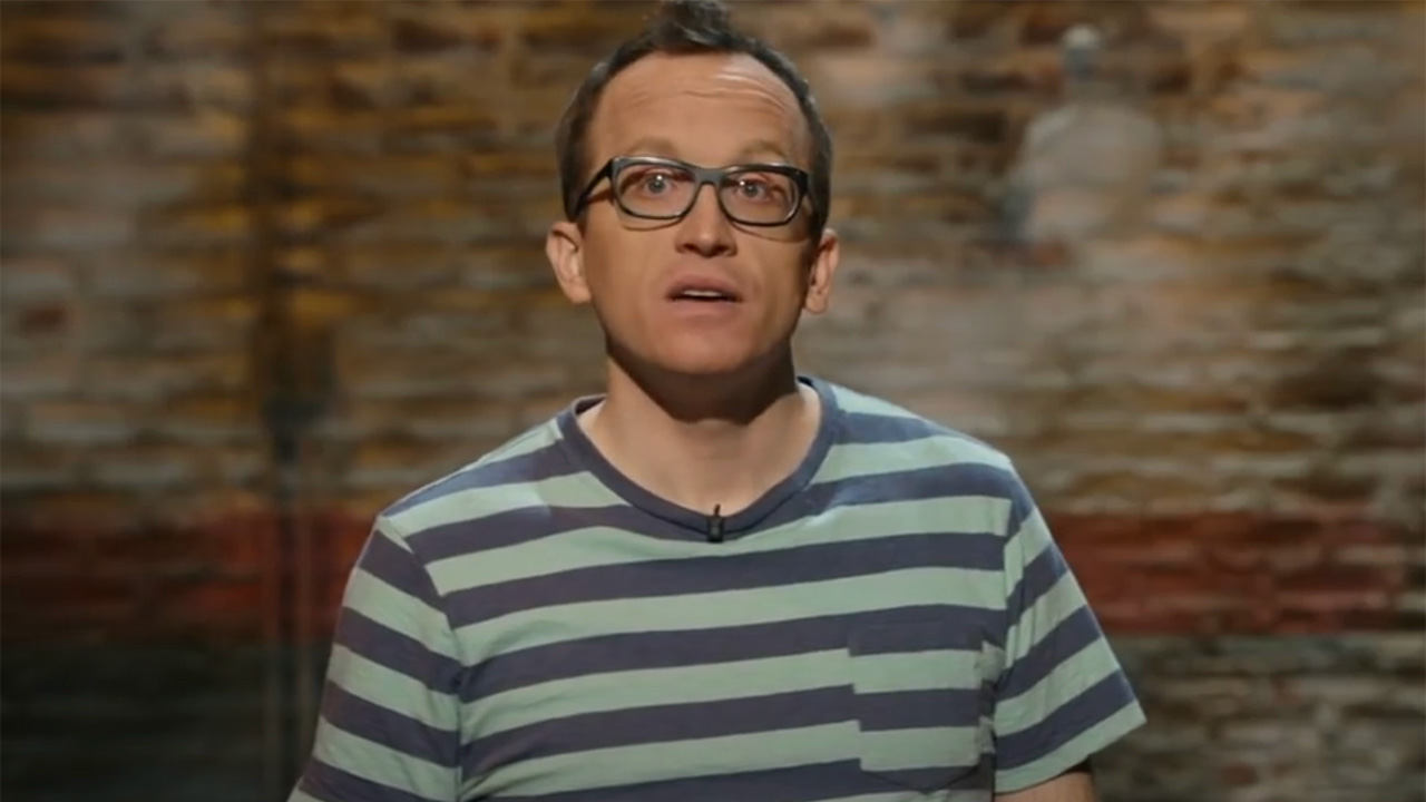 Chris Gethard in a striped shirt onstage for his HBO comedy special.