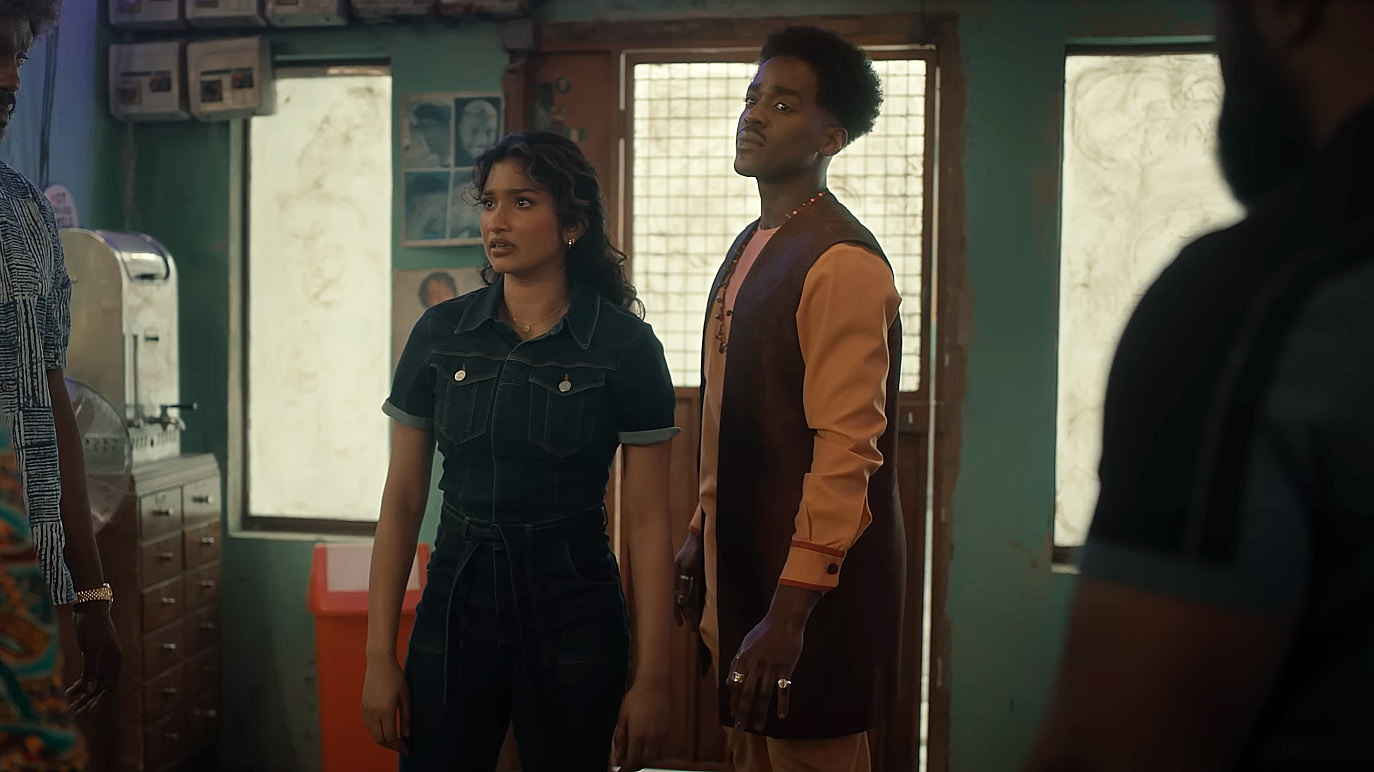 The Doctor and Belinda looking at people standing off-camera in Doctor Who season 2 episode 5