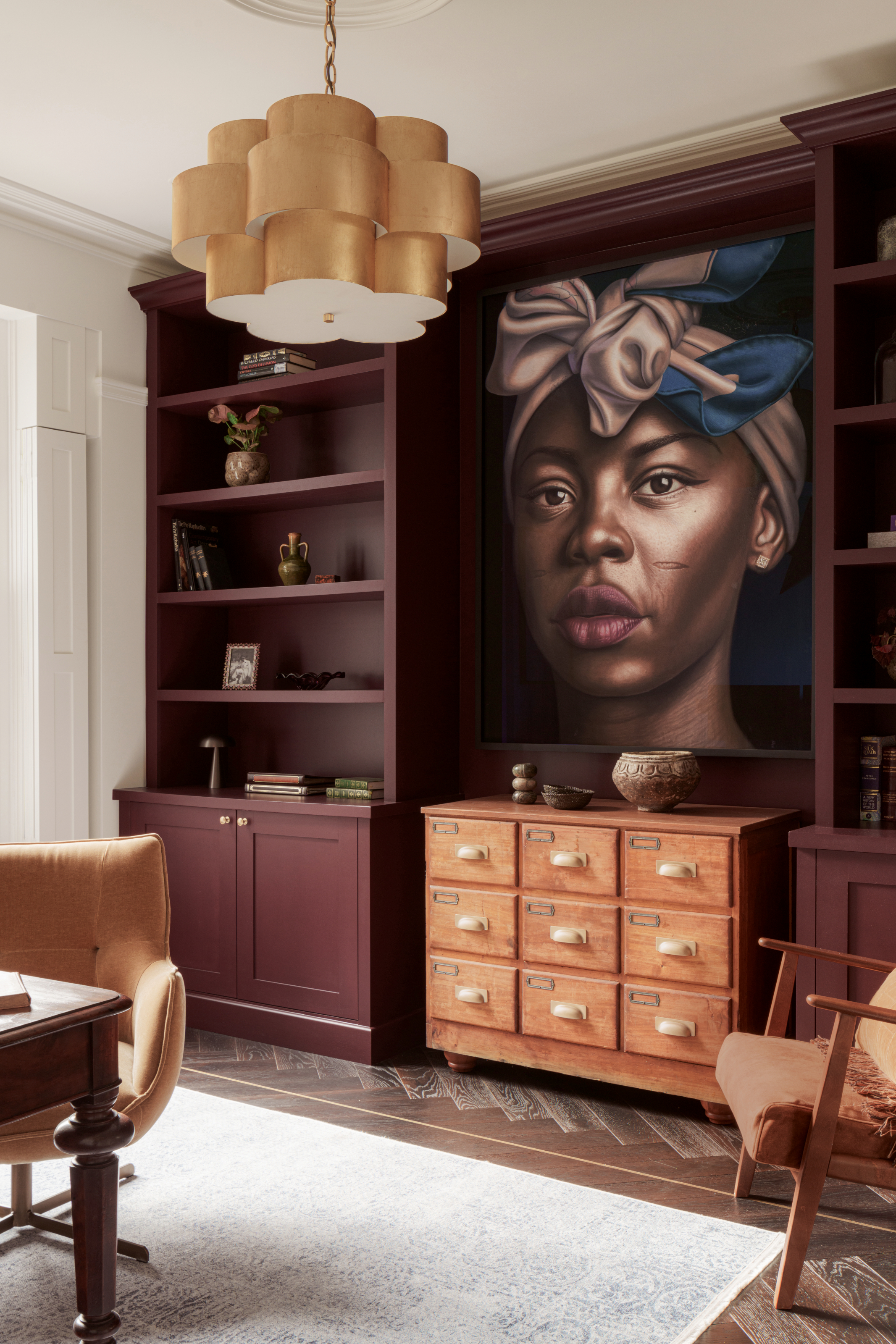 Office with burgundy built-in shelving and portrait