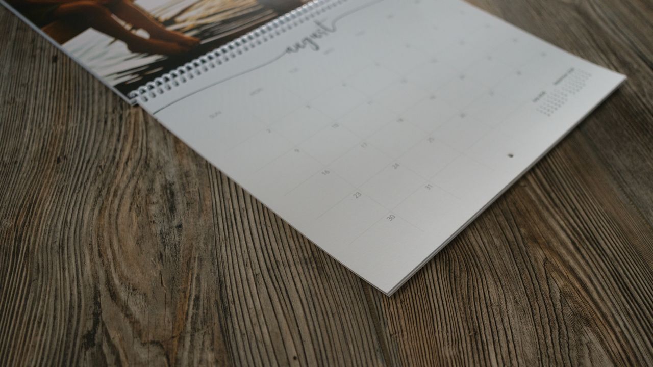 A photo calendar from Nations Photo Lab on a wood background