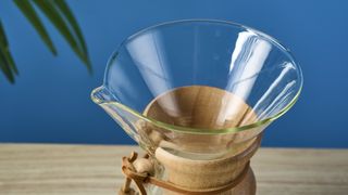 an hourglass coffee maker by Chemex with a 6 cup capacity and a wooden collar with a rawhide tie