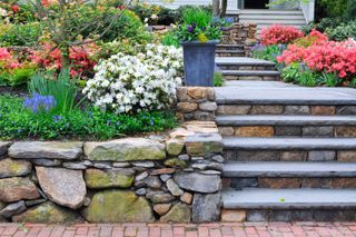 front garden wall ideas: low stone walls and steps in a front garden