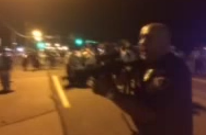 Cop points rifle at Ferguson protesters: 'I'll f**king kill you'