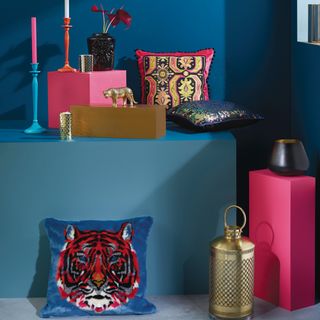 room with blue wall and tiger faux fur cushion and candles