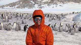 WHOI associate scientist and seabird ecologist Stephanie Jenouvrier working out in the field with emperor penguins.