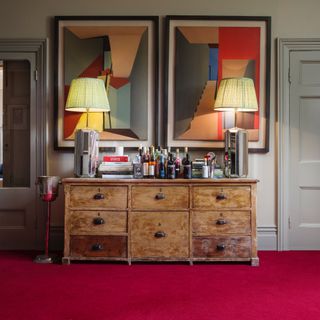 carpet colour trends for 2023, hallway with red carpet, vintage sideboard, large table lamps, large artwork