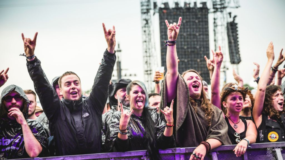 Fans celebrating the performance of a band at the Wacken Open Air festival on August 2, 2018 in Wacken, Germany.