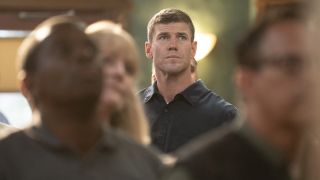 Austin Stowell's Gibbs standing in crowd on NCIS: Origins