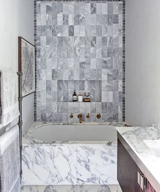 Parisian bathroom decor with marble bath surround