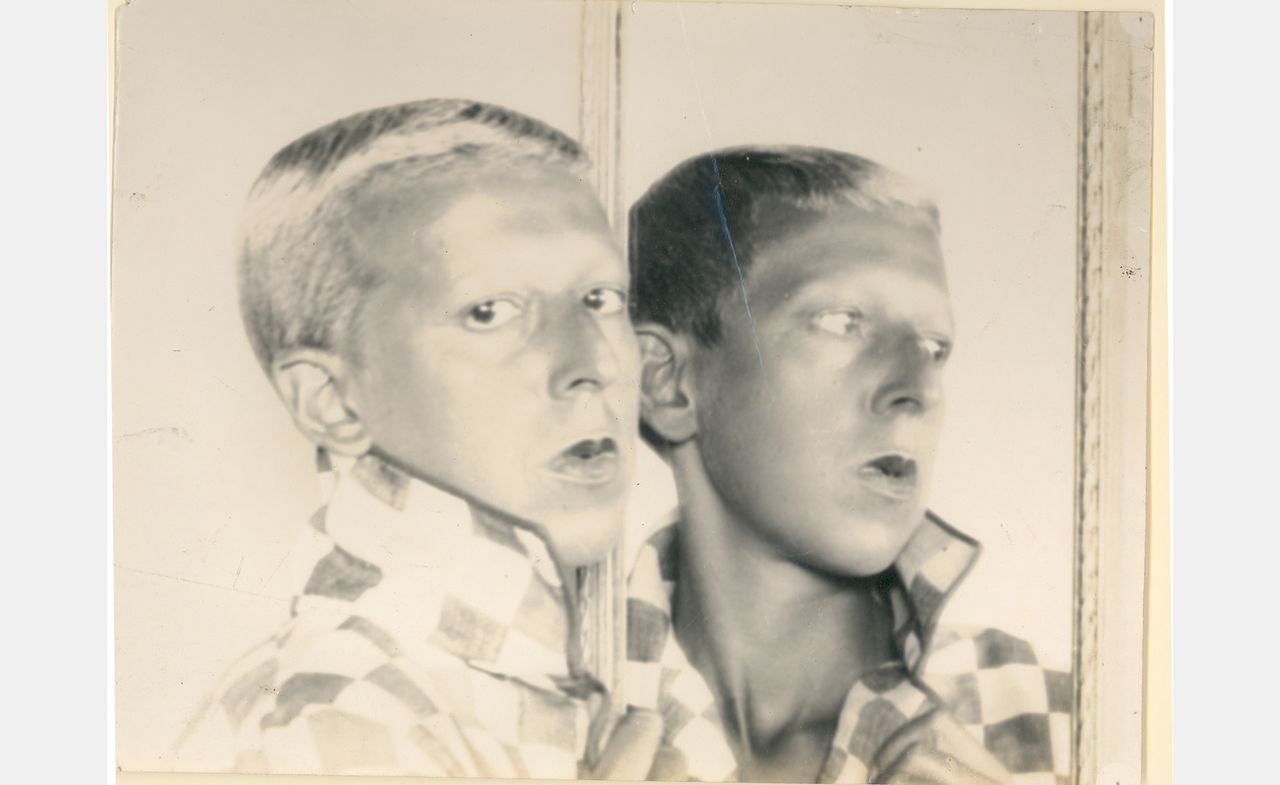 black and white photo of Claude Cahun, reflected in mirror