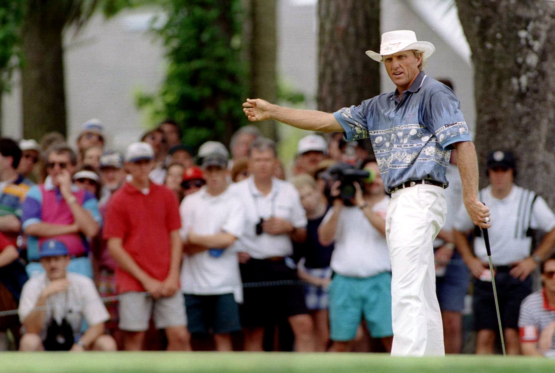 Greg Norman reacts to a putt