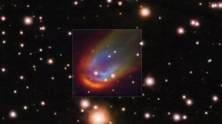 Image showing a multicolored bow shock surrounding a distant star