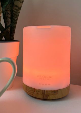 picture of lit up diffuser on bedside table