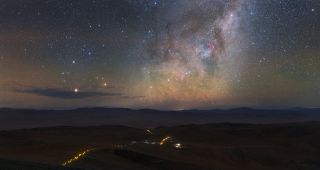 The Milky Way shimmers over Chile's Atacama Desert in this stunning view by astrophotographer Petr Horálek of the European Southern Observatory (ESO). The long line of yellow street lights marks the road between ESO's Paranal Observatory and the Residencia, a hotel that provides lodging for astronomers and other staff of the observatory.