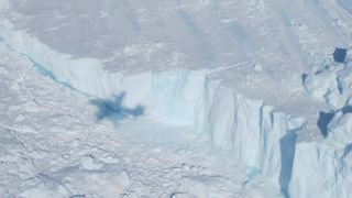 The shadow of a plane is visible in this photo of Greenland's Jakobshavn Glacier.